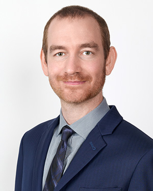 A portrait of Andrew Udelsman, a Staff Attorney at Florida Justice Institute