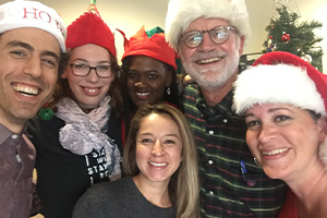 A group photo of team members of the Florida Justice Institute smiling at a Holiday party