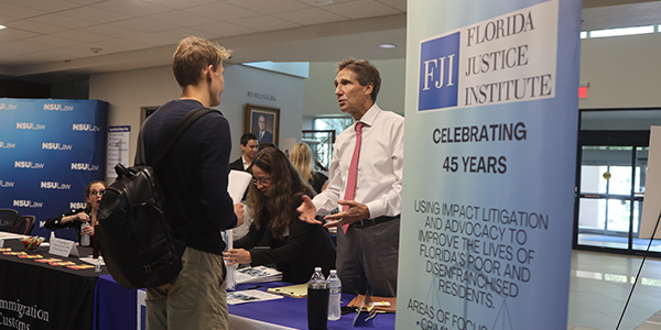 Ray Tasseff, an attorney for Florida Justice Institute, speaks at a convention to students and residents about the mission of FJI